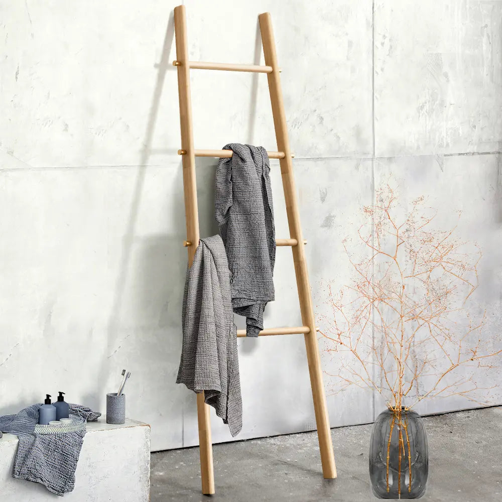 A sleek towel rail mounted on a bathroom wall, elegantly displaying neatly hung towels for easy access and organization.