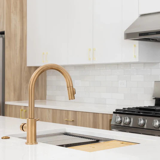 A stylish workstation kitchen sink with a large bowl, built-in accessories, and a contemporary faucet for versatile cooking tasks.