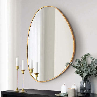 Tate irregular metal wall mirror in a modern living room in gold