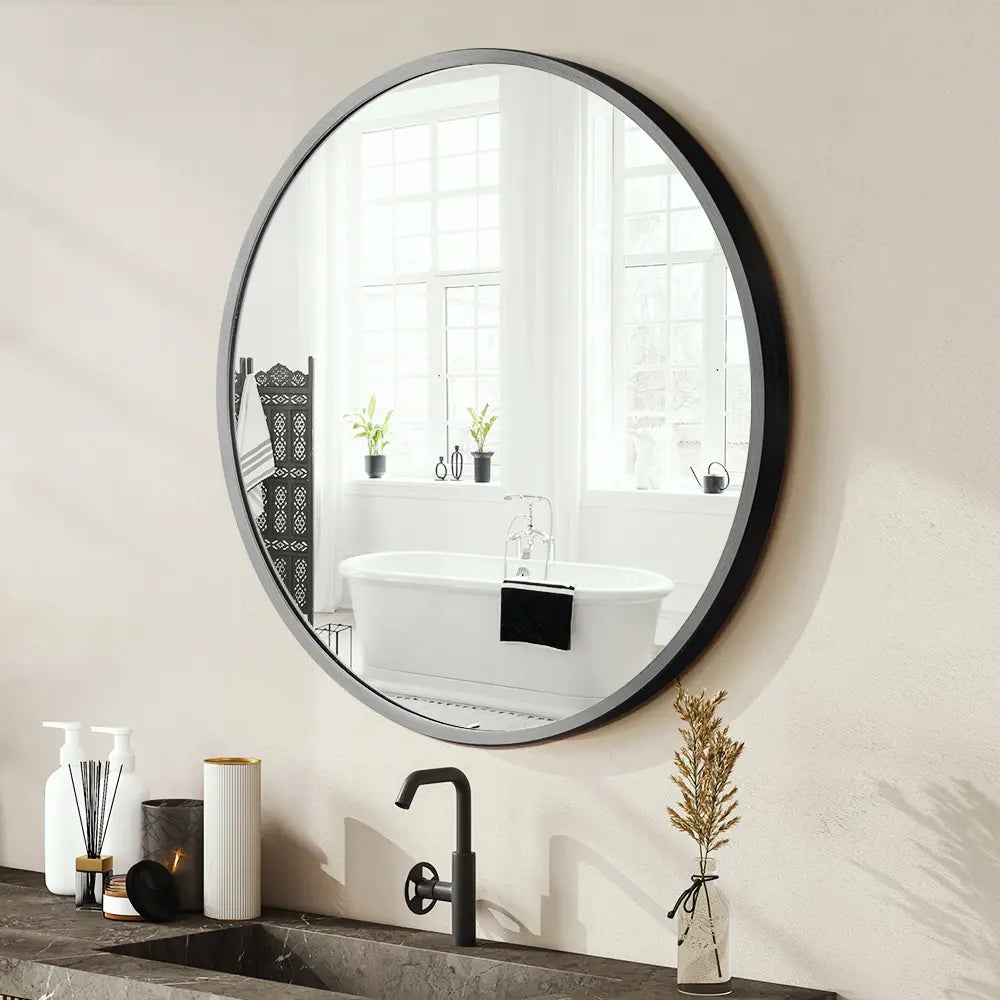 Round bathroom vanity wall mirror with sleek aluminium frame in a modern bathroom