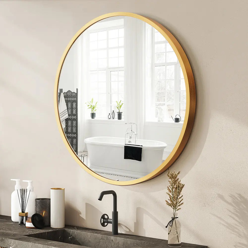 Round bathroom vanity wall mirror with sleek aluminium frame in a modern bathroom in gold