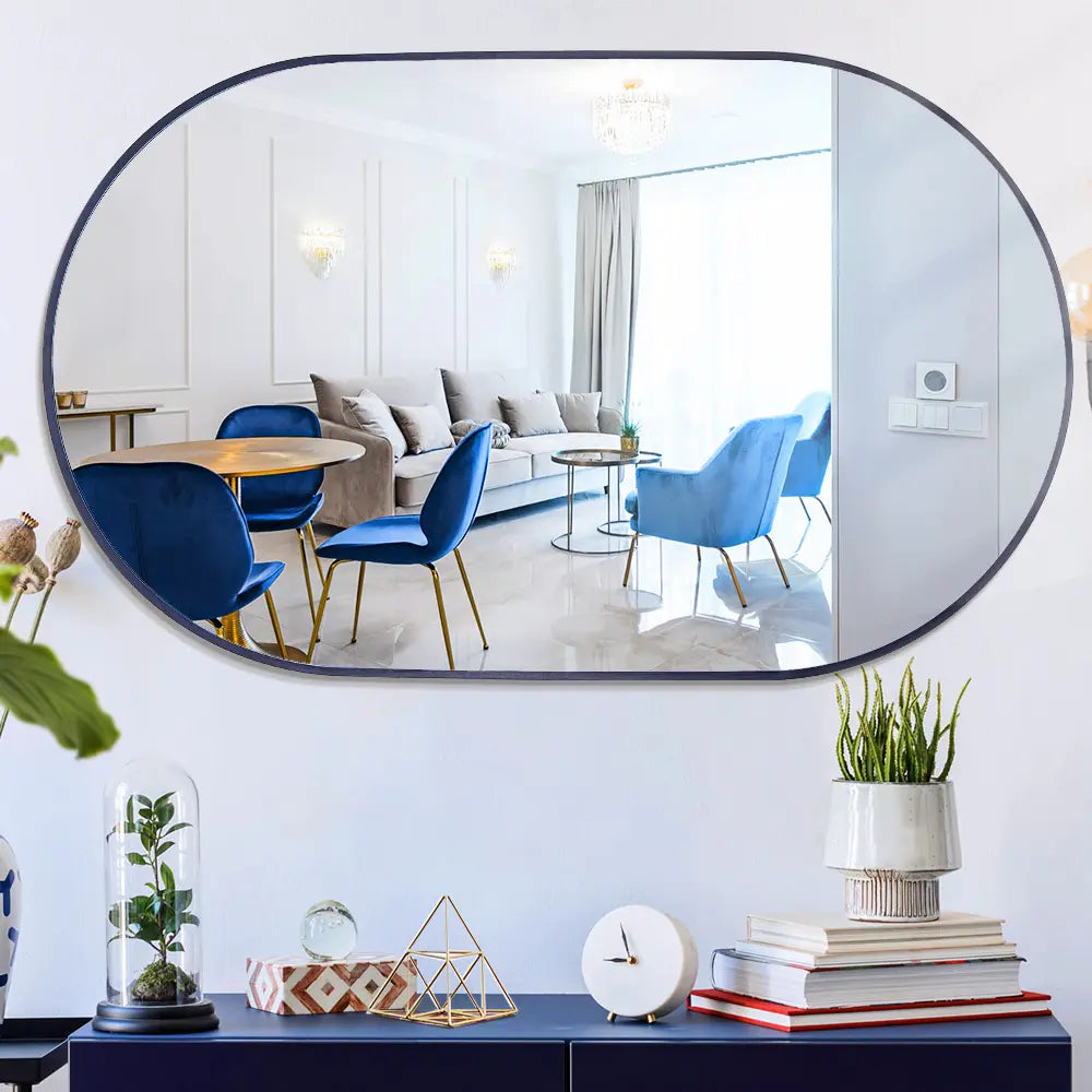 Slim-framed oval mirror in a minimalist bathroom setup