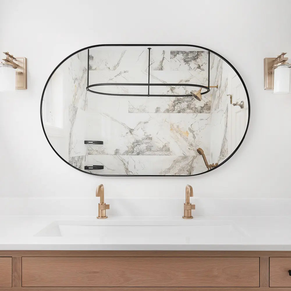 Oval vanity mirror with aluminium frame mounted on a tiled bathroom wall