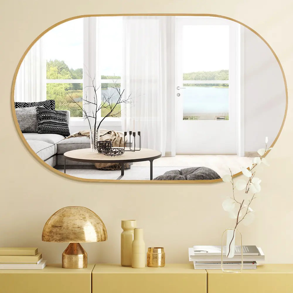 Oval vanity mirror with aluminium frame mounted on a tiled bathroom wall