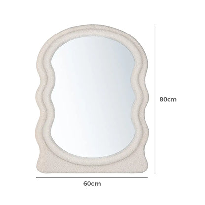 Modern boucle fabric wall mirror in a well-lit space