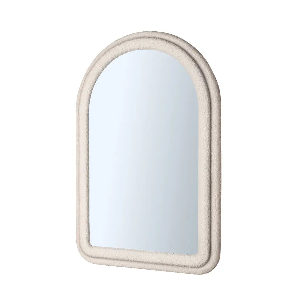 Arched wall mirror with fabric-wrapped frame close-up