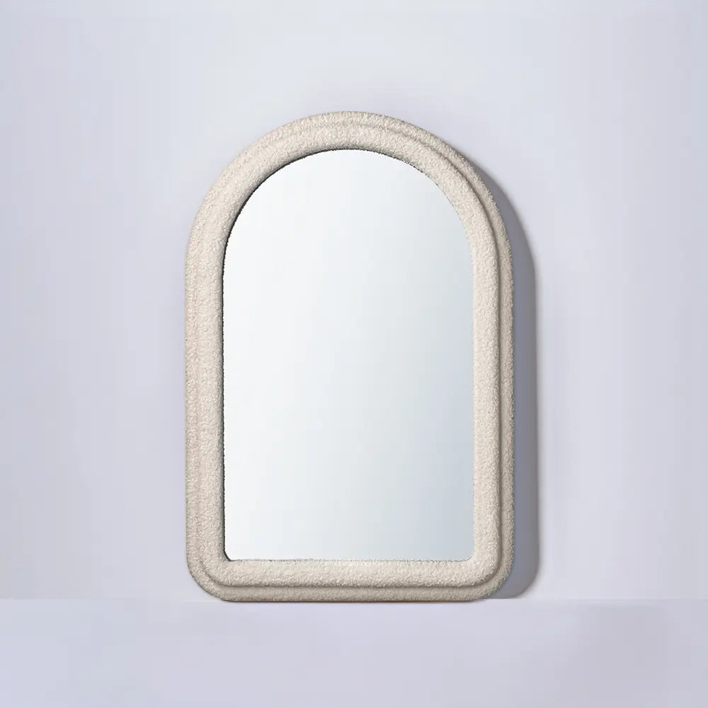 Halo arch mirror hanging above a console table