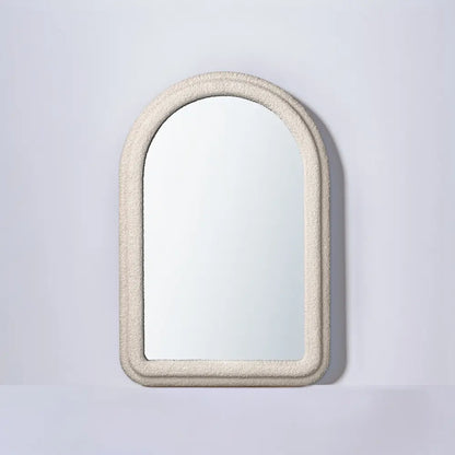 Halo arch mirror hanging above a console table