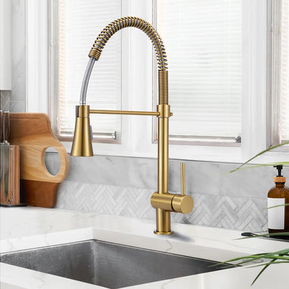 Vivi spring mixer tap with pull-down spout in modern kitchen in gold