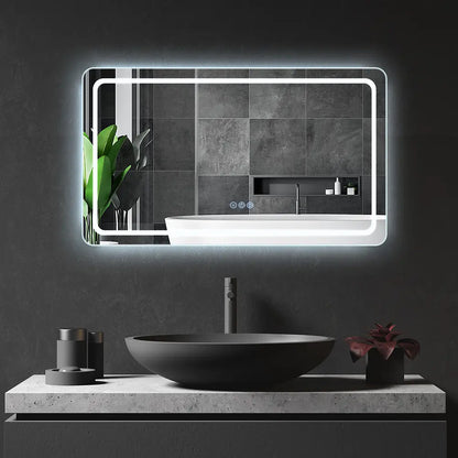 Frontlit LED lighted rectangular mirror installed above a bathroom vanity