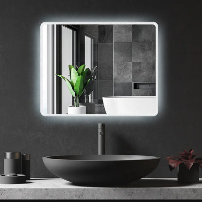 Frameless rectangular LED lighted wall mirror with rounded corners in modern bathroom