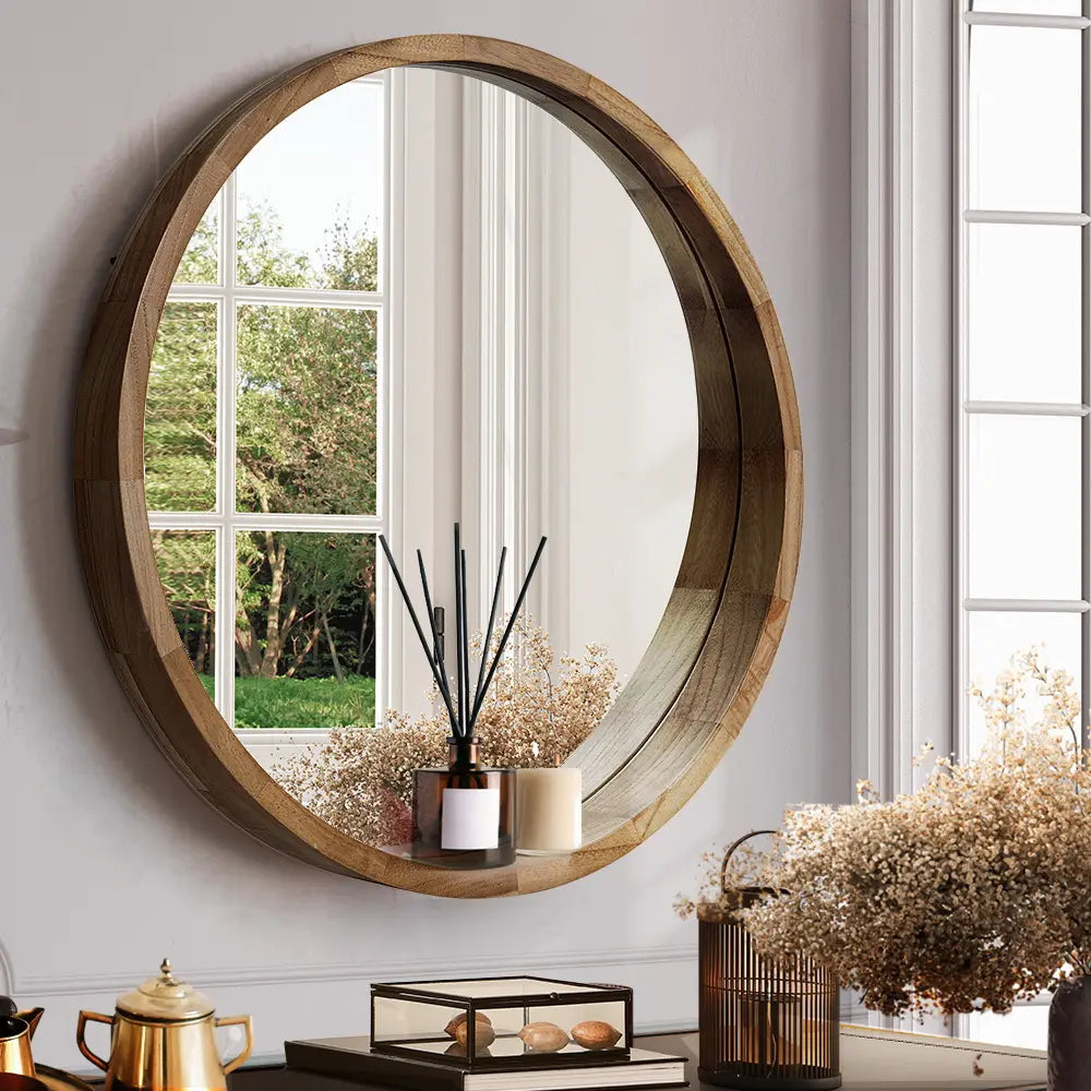 Libra Large Round Solid Wood Frame Wall Mirror in living room with natural wood finish